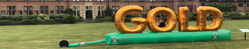 Gold banner sat in front of HCA building